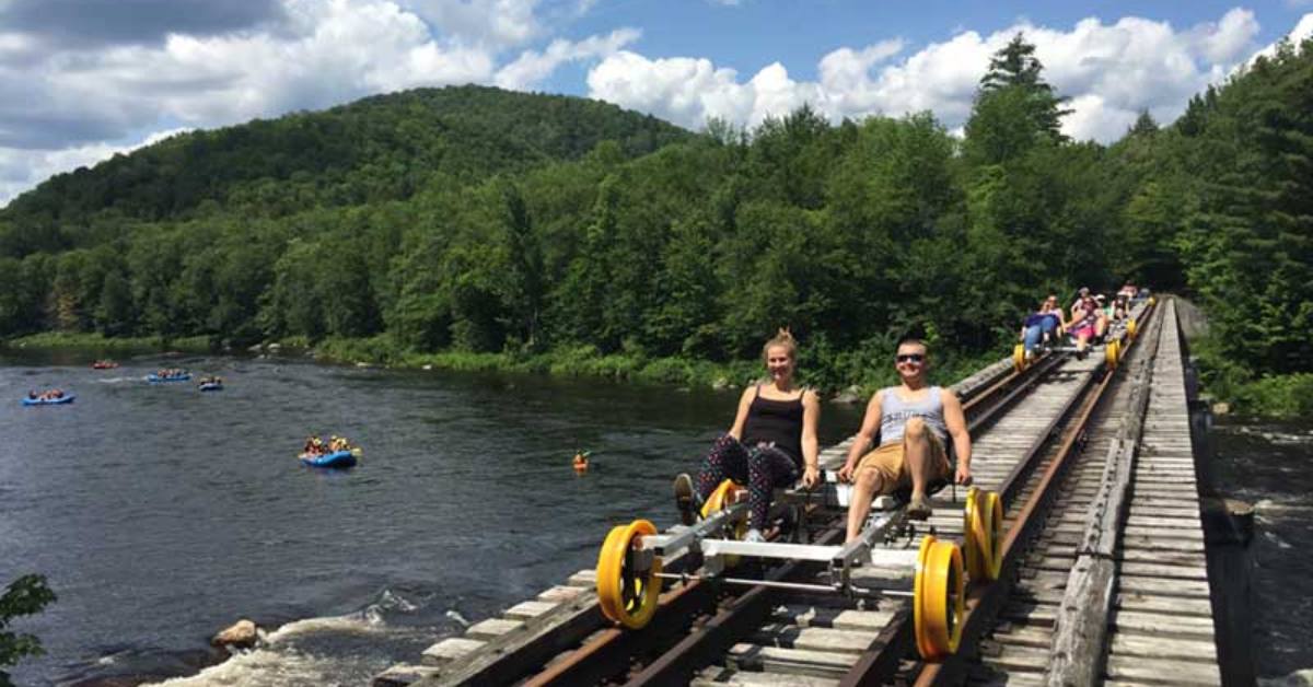 people on a railbiking course over a river