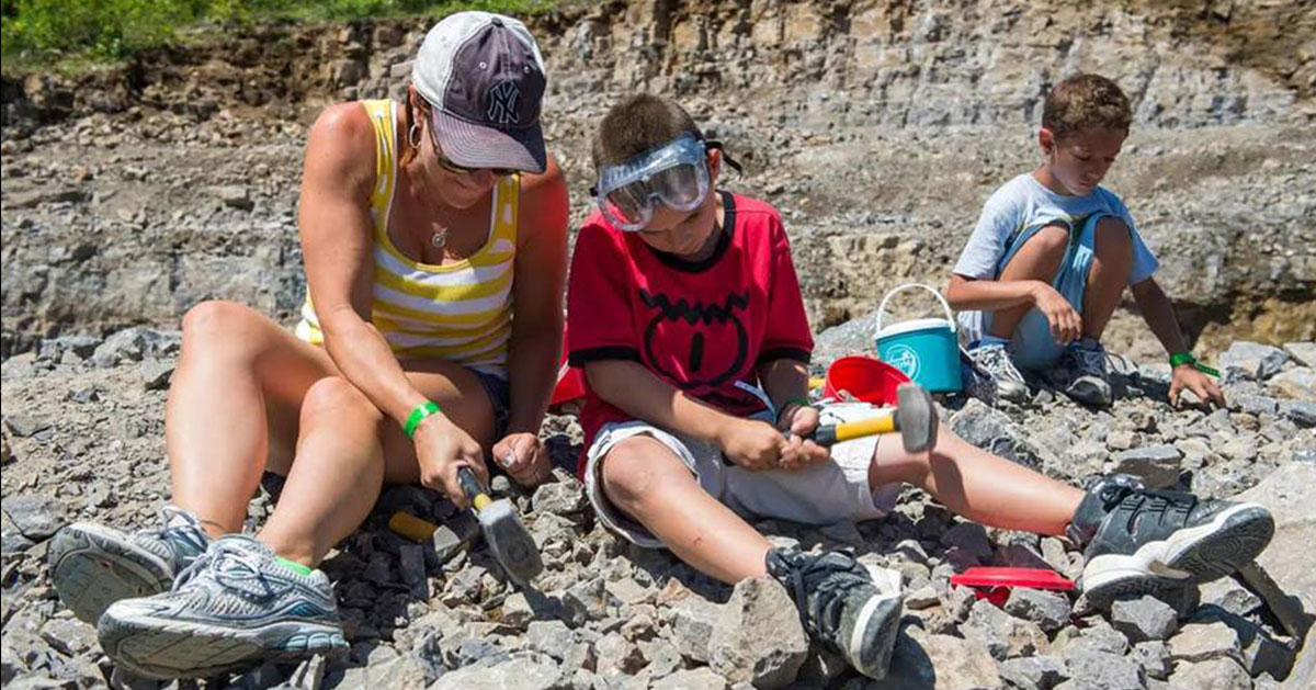 three people mining rocks