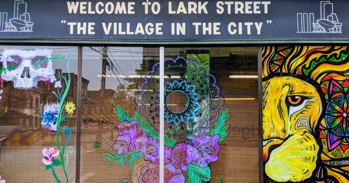 Lark Street window and sign saying welcome