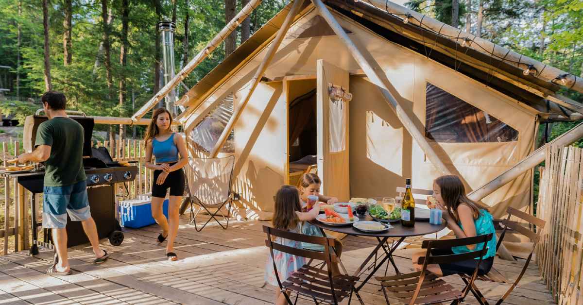 man, woman, and three girls at a luxury tent