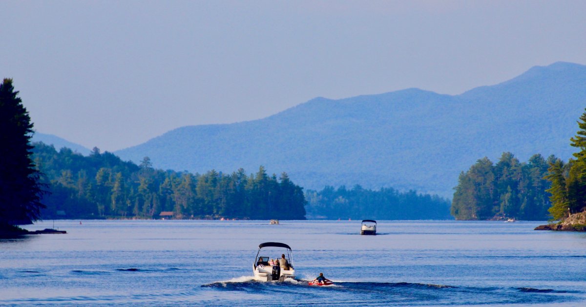 boat pulling a tube on a lake