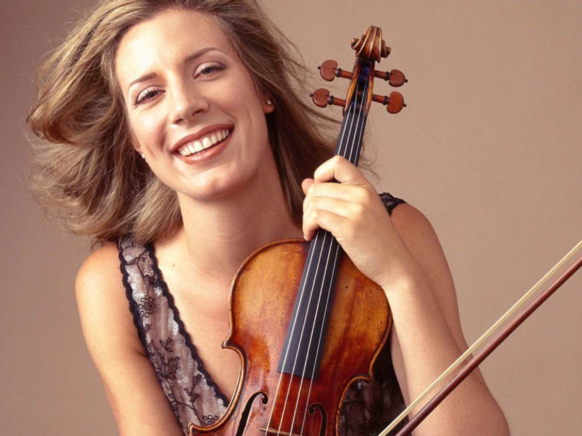 a woman smiling with a violin