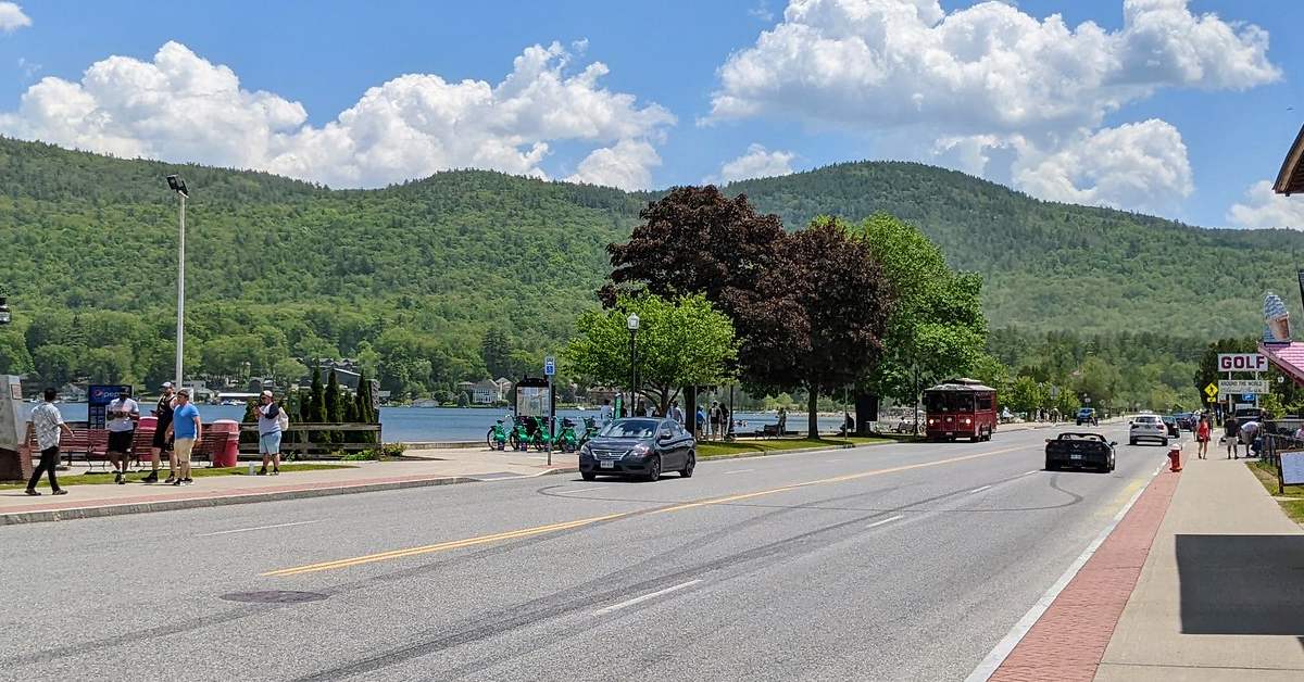 beach road in lake george, people walking, trolley