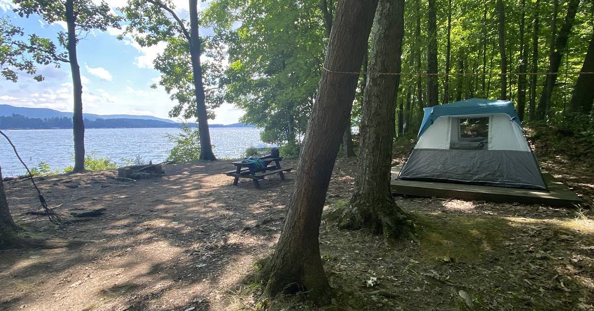 campsite near water with a tent