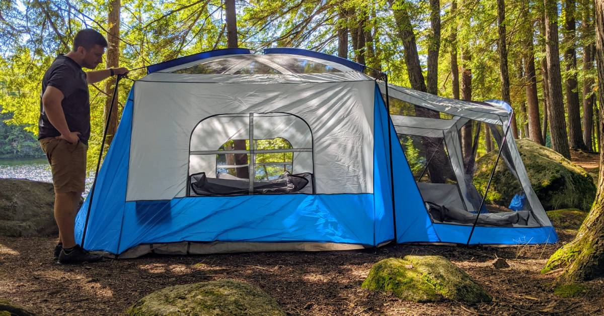 guy with camping tent in woods