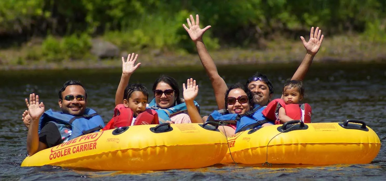 family waves while tubing