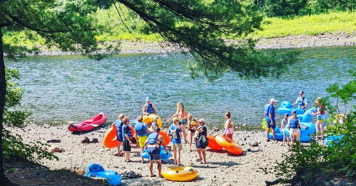 lazy river tubers on shore by the water