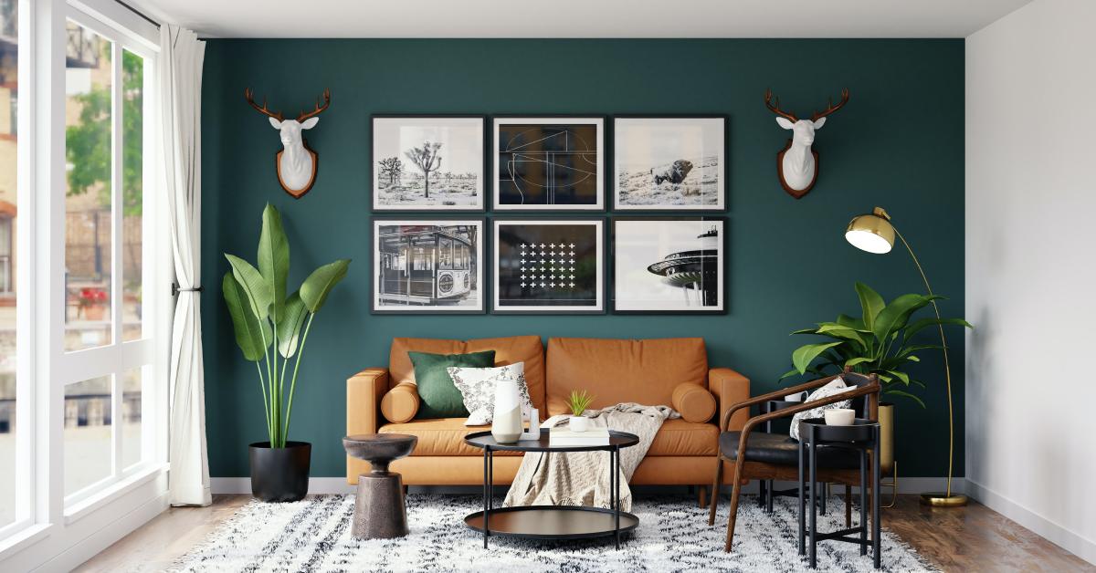 room in a house with green wall and leather couch