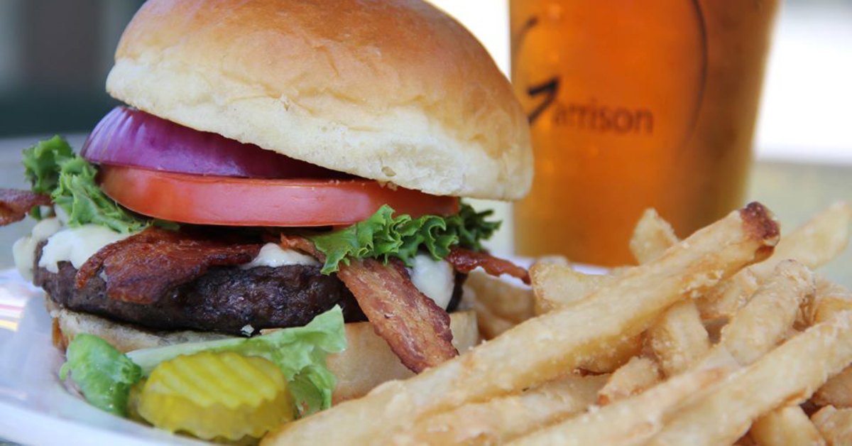 burger and fries with a beer in the background