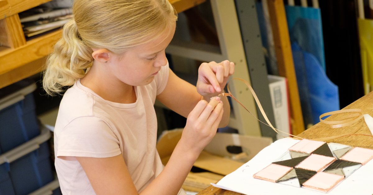 young girl working with stained glass