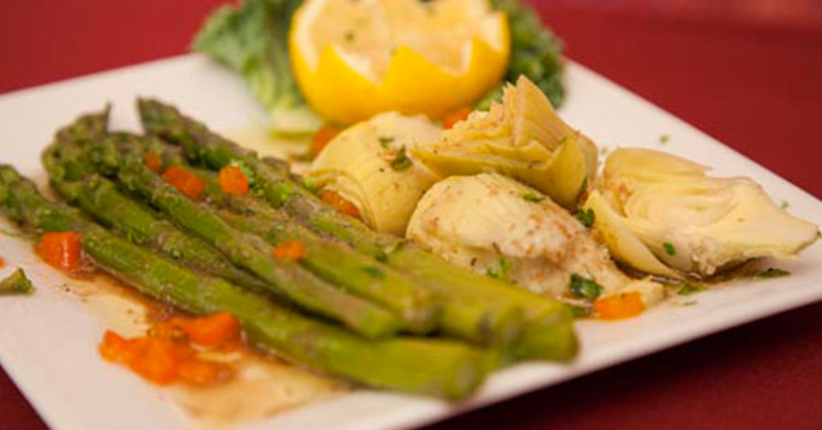 plate with asparagus and artichokes on it