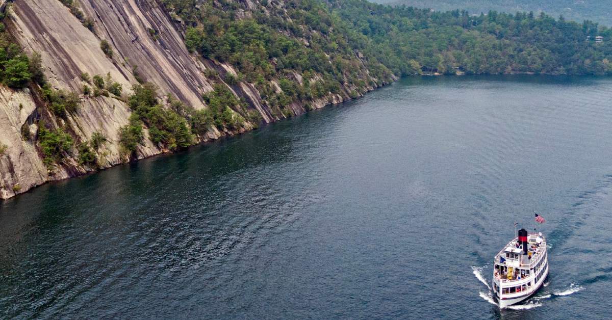 cruise ship near a large cliff