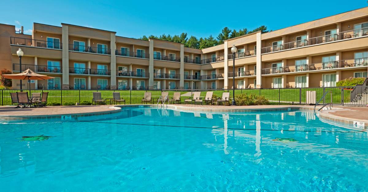 pool with a hotel behind it