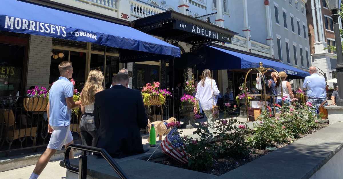 people walking by The Adelphi Hotel in downtown Saratoga