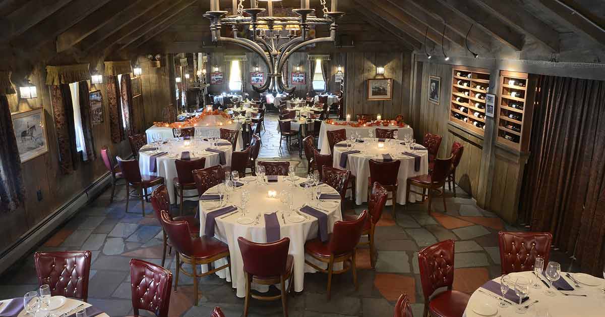 dining room set up with white table-clothed tables