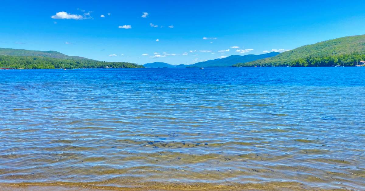 blue water in front of mountains