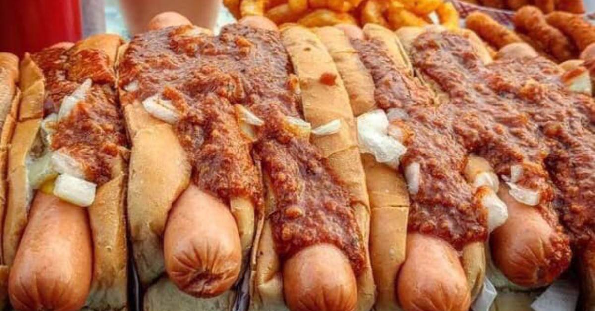 hot dogs covered in onions and meat sauce