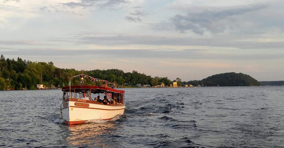 a boat out on the water at sunset