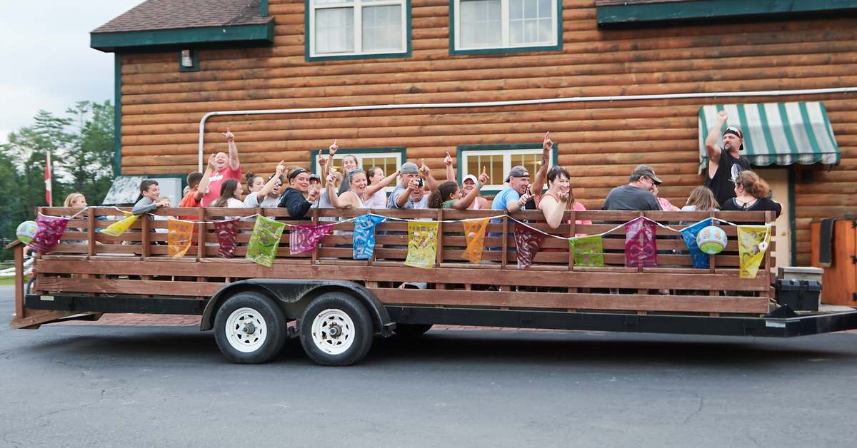 campers on a wagon ride looking excited