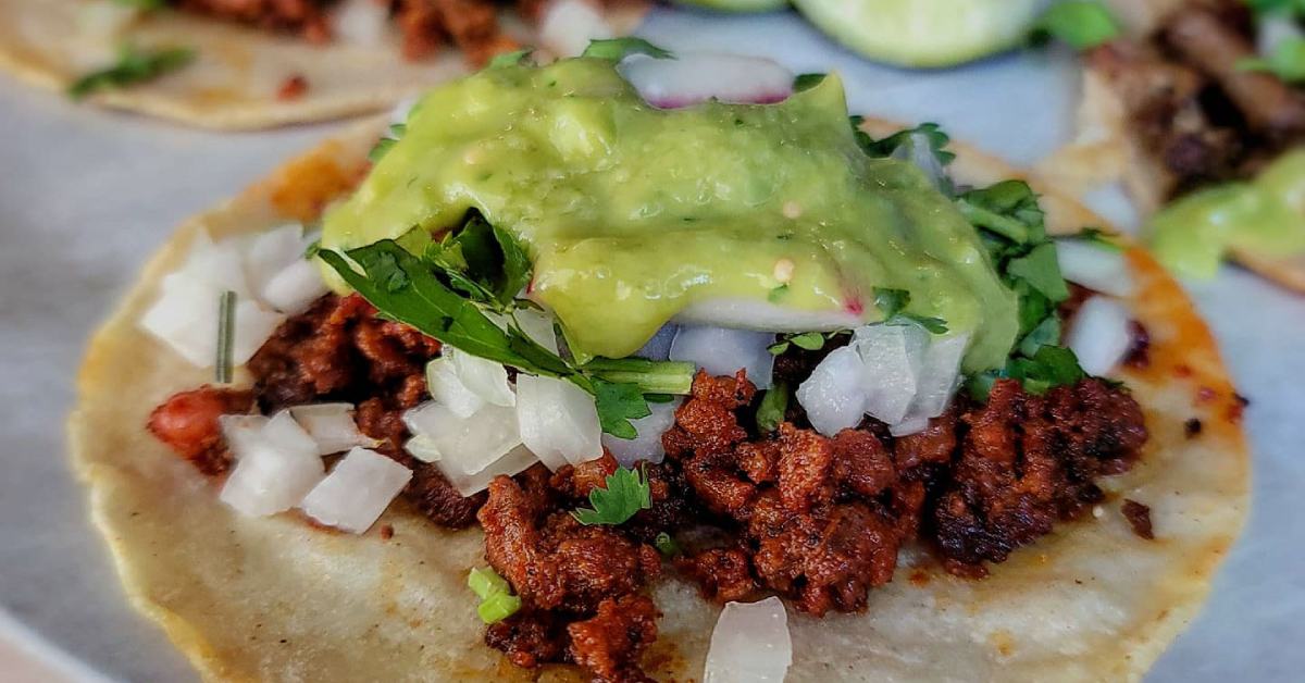 taco with meet, onions, and guacamole