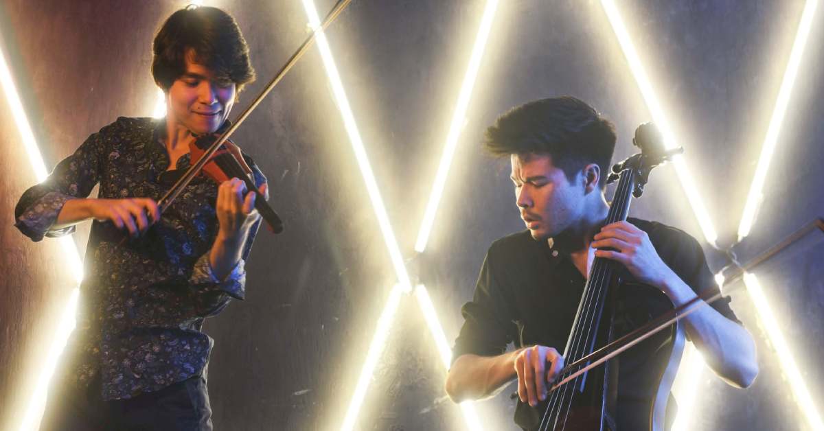 two musicians play, one man with a fiddle-like instrument, the other a cello or bass