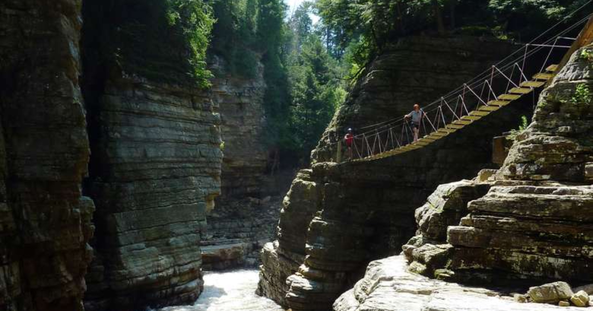 person crossing a rope bridge