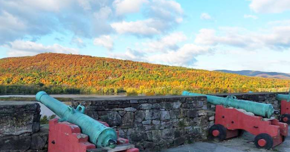 two cannons with a mountain in the background