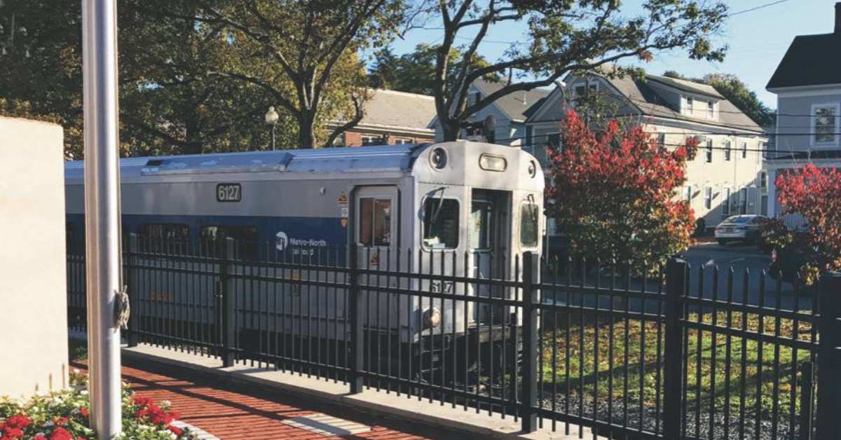 a train on the other side of a fence