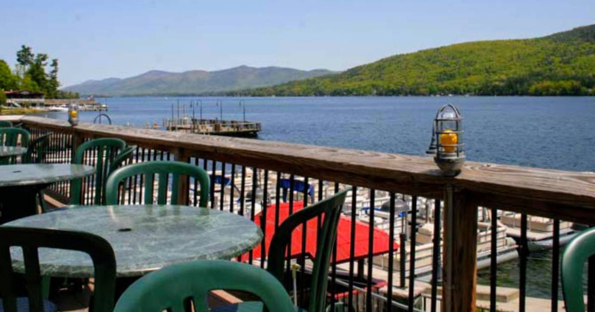 tables and chairs on deck overlooking a lake