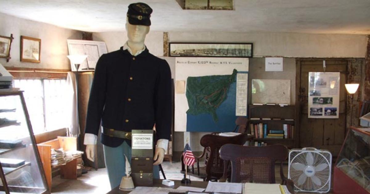 interior of a museum with a manequin dressed in civil war era clothes