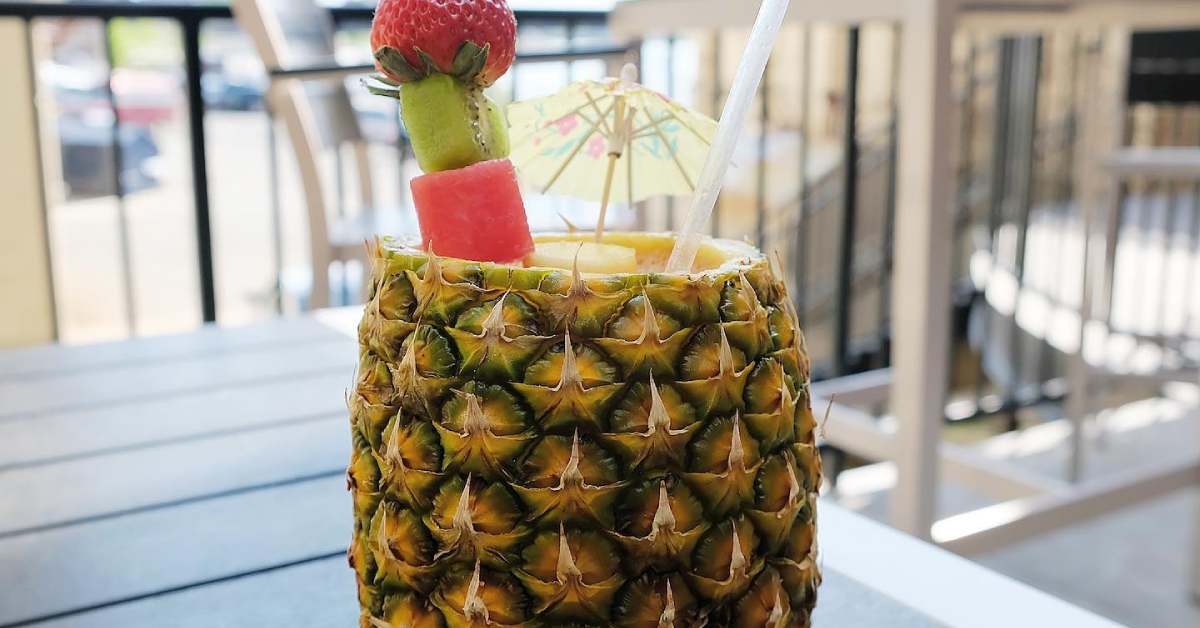 a drink that uses half a pineapple as the glass