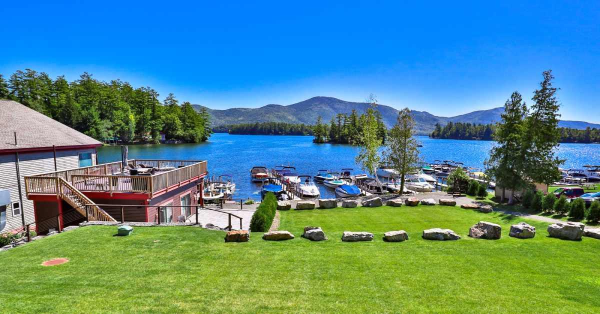 a grassy area overlooking a lake with boats