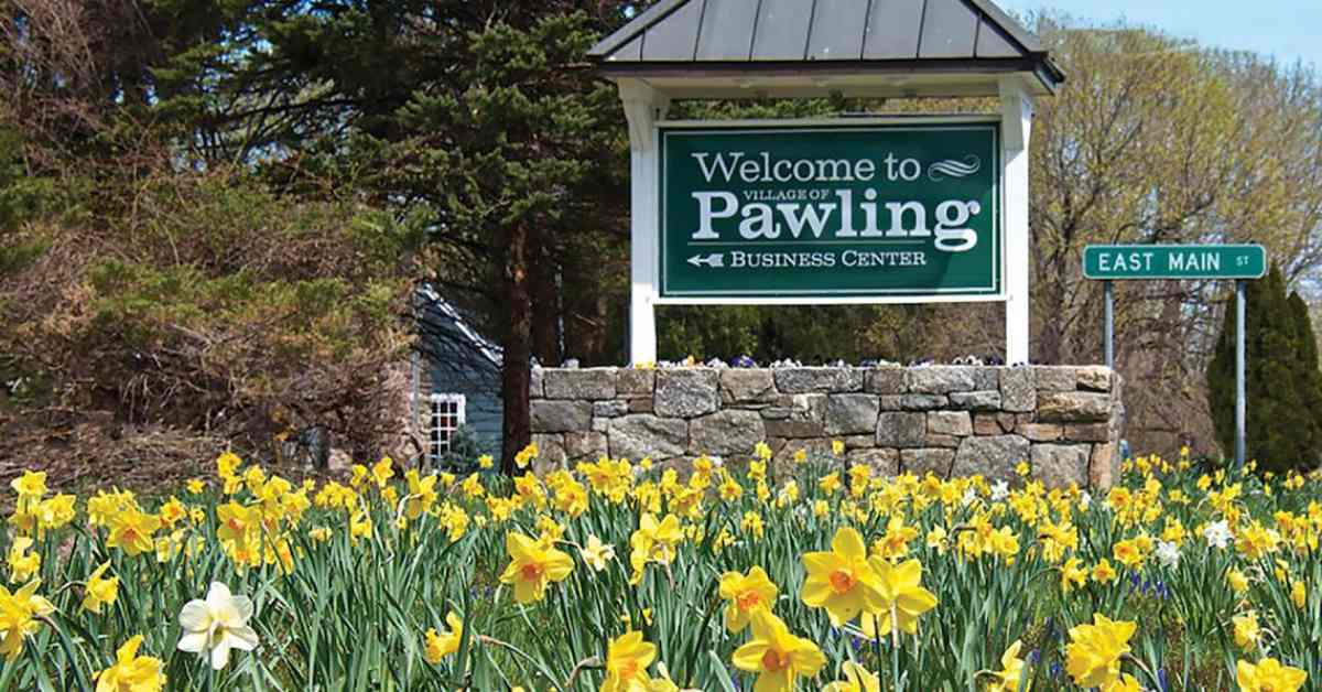 welcome to pawling sign with tulips in front of it