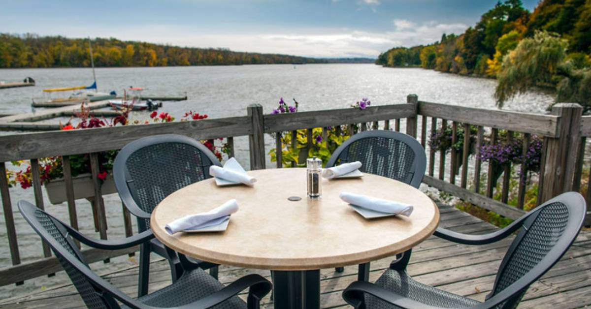 a restaurants table and chairs overlooking water