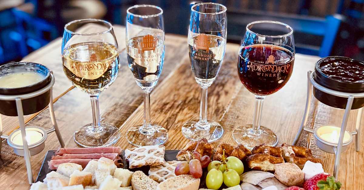 wine glasses and a charcuterie board on a table
