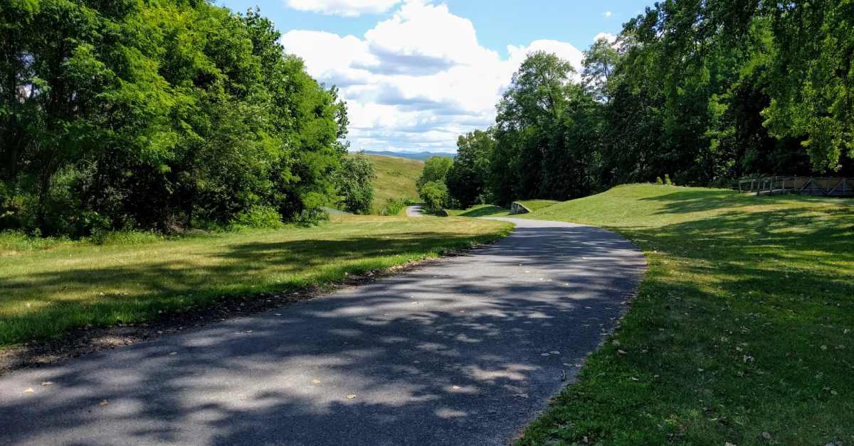 paved trail with rolling hills in background