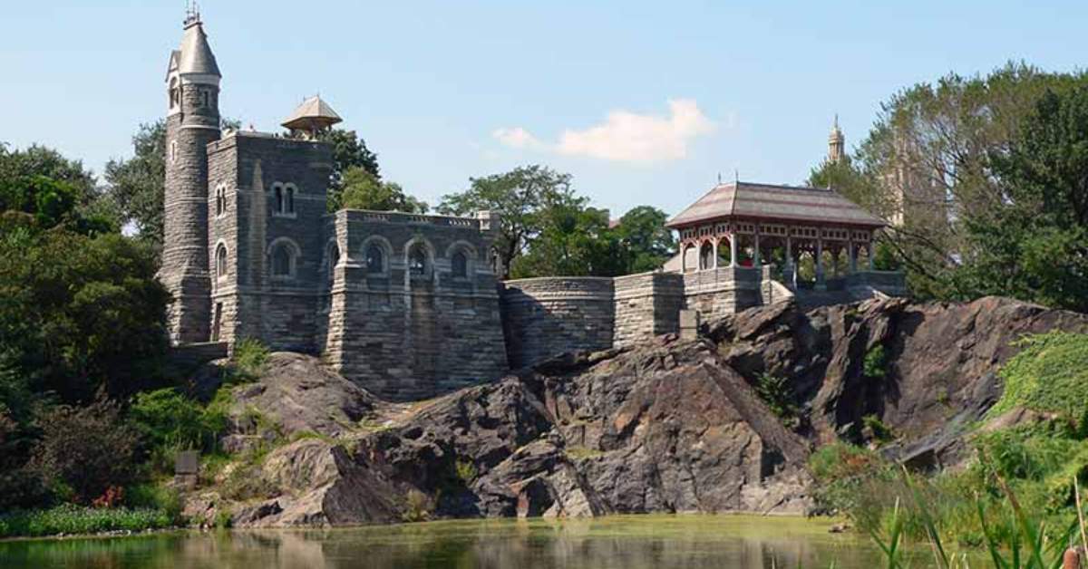 castle sitting on a cliff over water