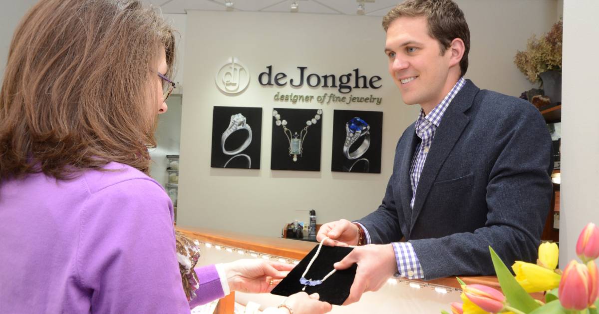 jewelry consultant showing a woman a necklace