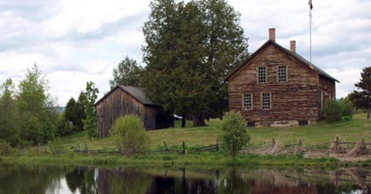 brown house overlooking a pond