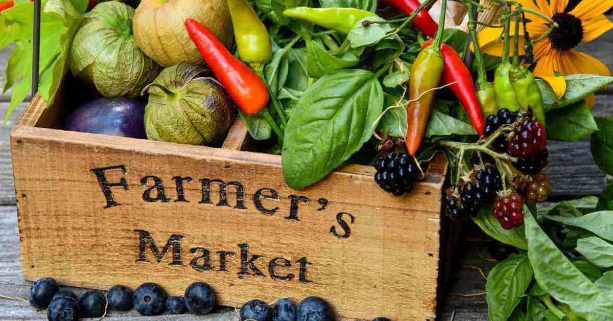 Box of Fruits and Veggies in a wooden box labeled 'farmer's market'