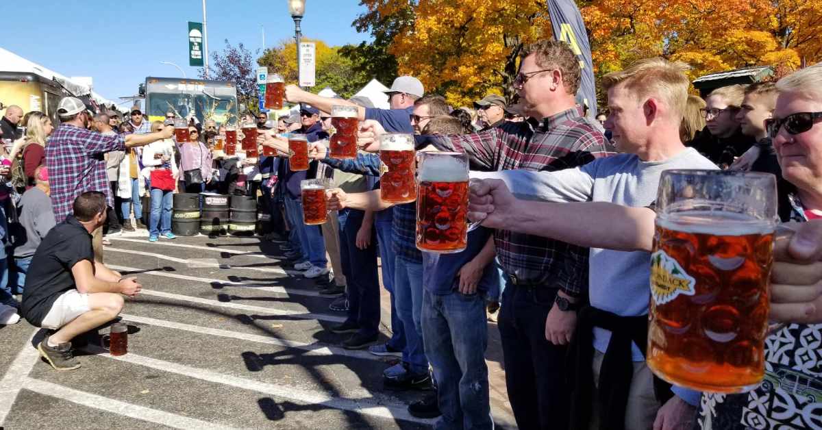 line of people holding steins in front of them