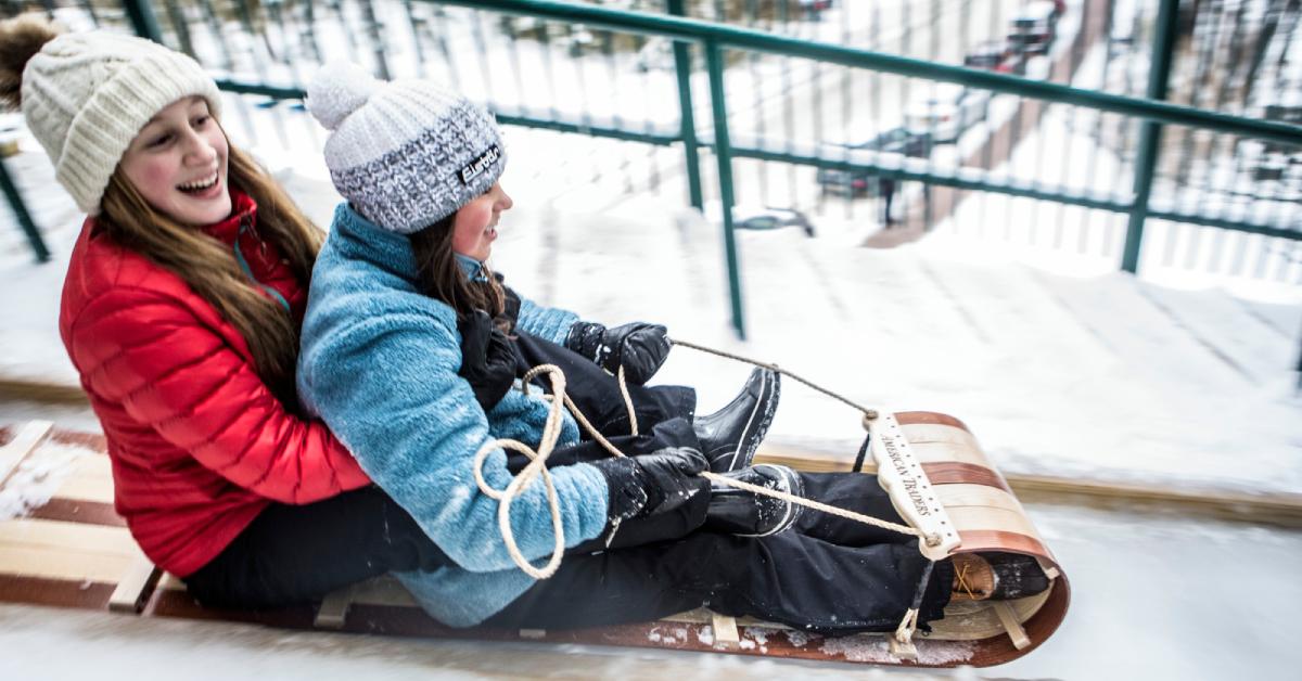 two girls going down a toboggan chute