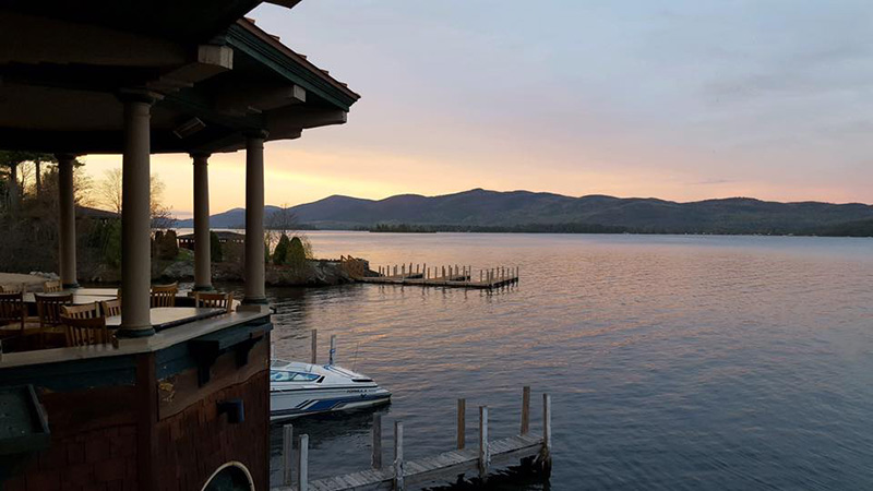 View of sunset and the Adirondack mountains from The Boathouse Restaurant on Lake George