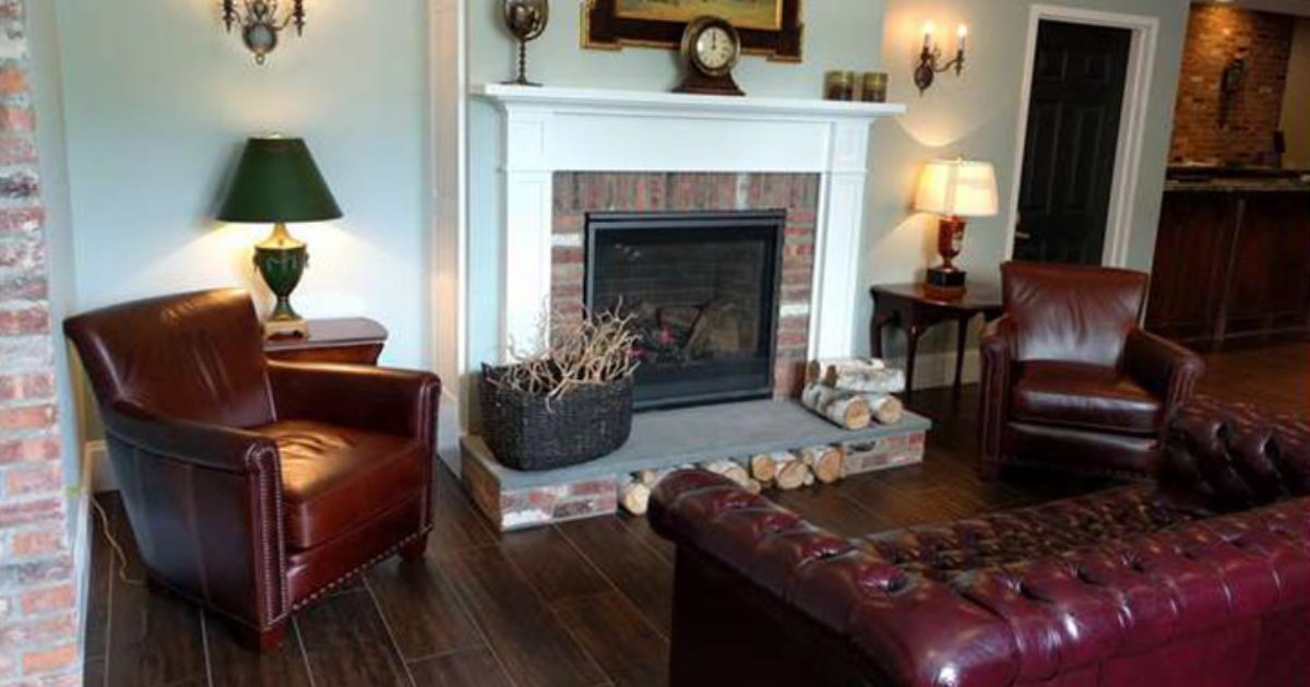 red chairs and sofa near a fireplace