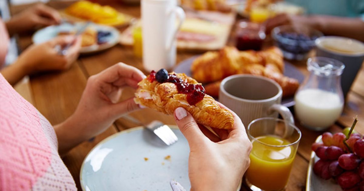 person eating breakfast baked good