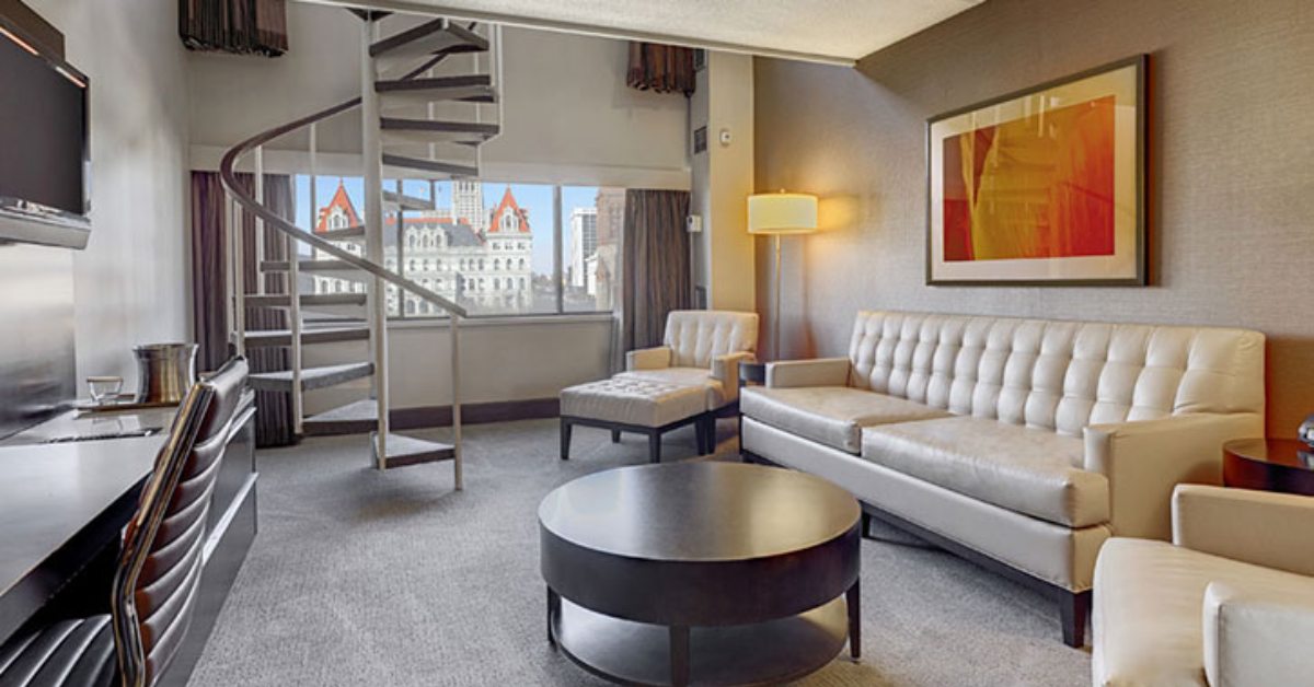 hotel guest room lounge with staircase and couches