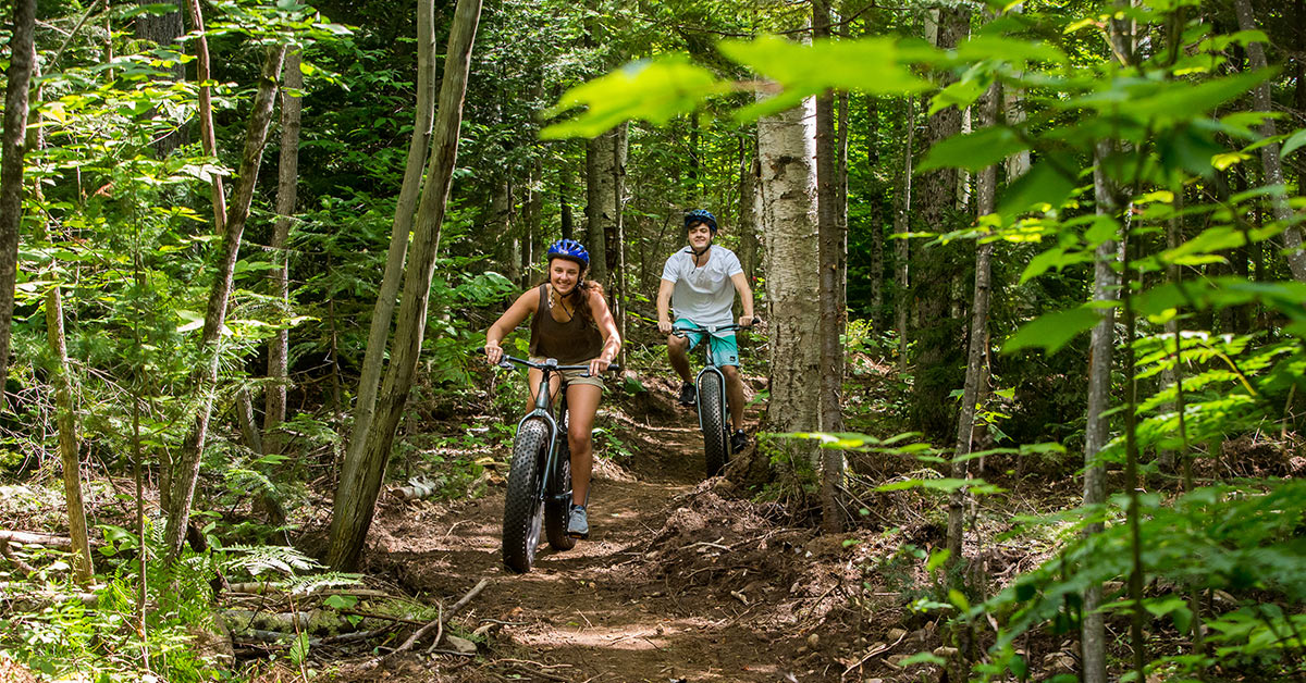 two young adults riding fat tire bikes