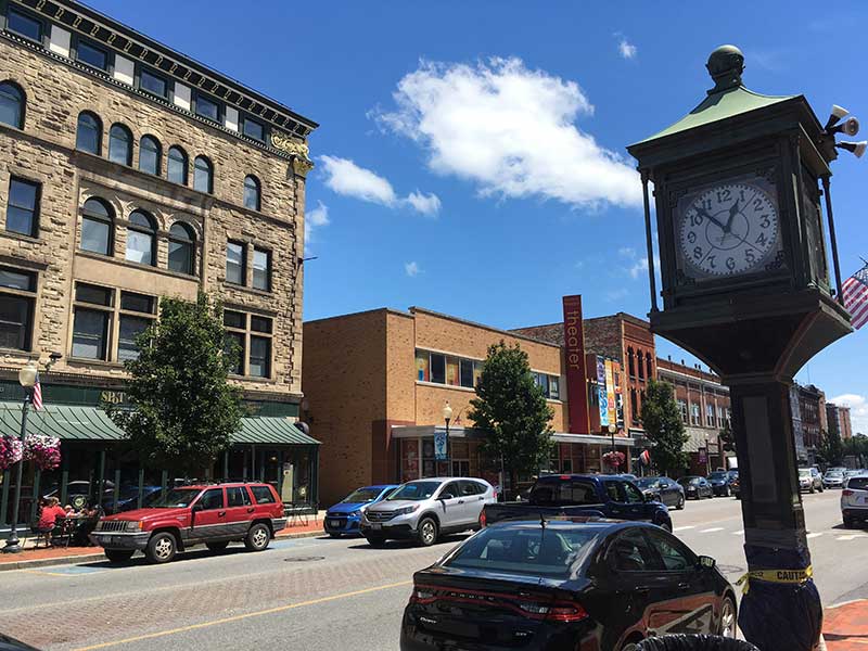 a street in downtown glens falls on a sunny day