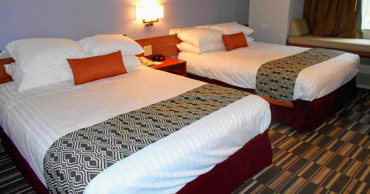 a hotel room with two beds