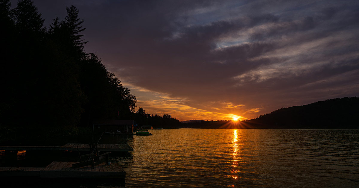 sun setting over seventh lake